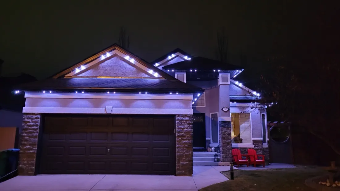 Calgary home lit in purple and blue permanent LED colours selected from the control app