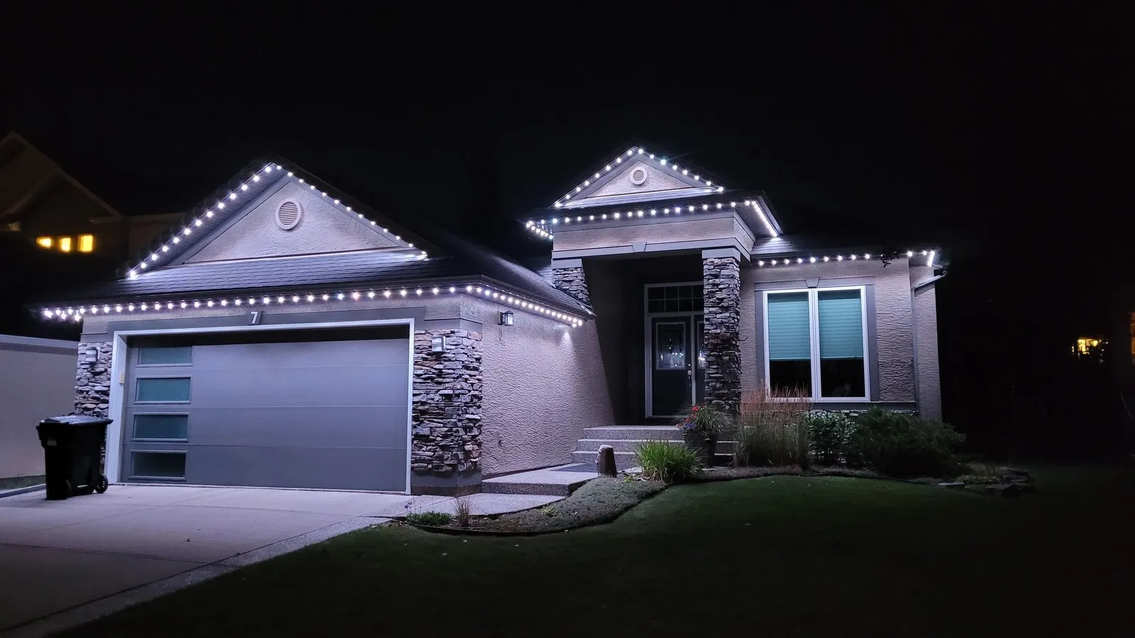 Residential permanent lighting on a Calgary home lit at night